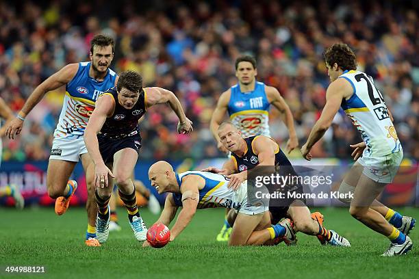 Gary Ablett of the Suns is tackled by Scott Thompson of the Crows during the round 11 AFL match between the Adelaide Crows and the Gold Coast Suns at...