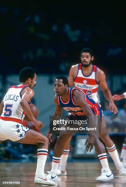 John Lucas of the Washington Bullets dribbles the ball while guarded by Vinnie Johnson of the Detroit Pistons during an NBA basketball game circa...