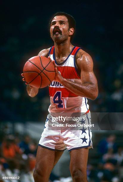 John Lucas of the Washington Bullets stands at the line to shoot a free throw against the New York Knicks during an NBA basketball game circa 1982 at...