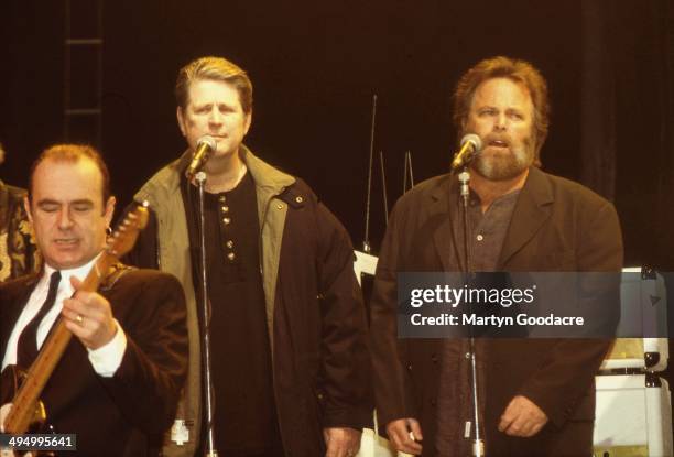 Francis Rossi of Status Quo performs on stage with Brian Wilson And Carl Wilson of the Beach Boys Brixton, London, United Kingdom, 1996.