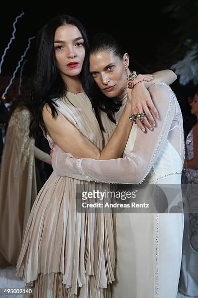 Model Mariacarla Boscono and model Magosia Bela attend the Gala event during the Vogue Fashion Dubai Experience 2015 at Armani Hotel Dubai on October...