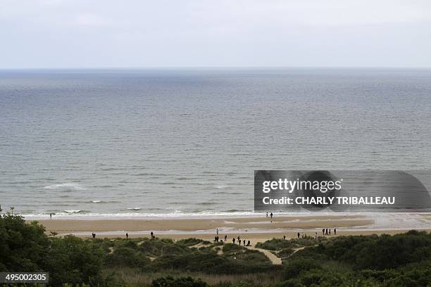 People visit on May 31 Omaha Beach in Colleville-sur-Mer, northwestern France. , one of the sites of the Overlord Operation where US soldiers landed...