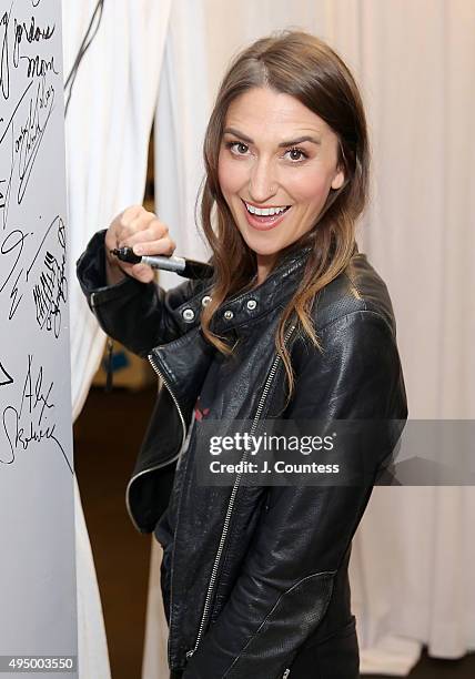 Singer Sara Bareilles signs the wall following the AOL BUILD Presents: "Sounds Like Me: My Life In Song" at AOL Studios In New York on October 30,...