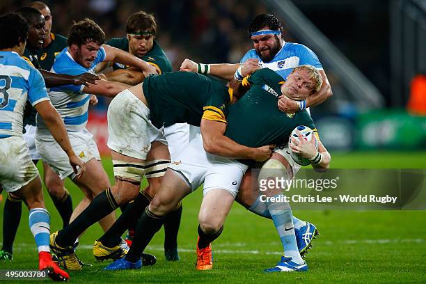 Adriaan Strauss of South Africa is tackled by Ramiro Herrera of Argentina during the 2015 Rugby World Cup Bronze Final match between South Africa and...