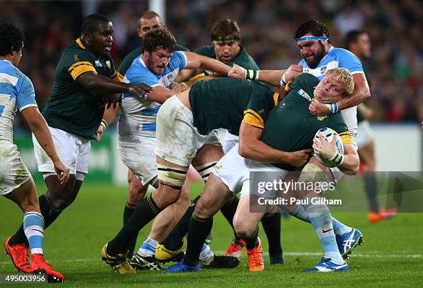 Ramiro Herrera of Argentina tackles Adriaan Strauss of South Africa during the 2015 Rugby World Cup Bronze Final match between South Africa and...