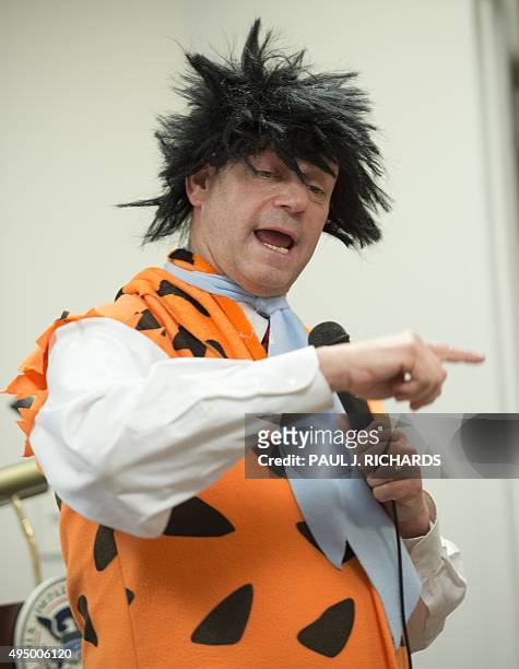 Leon Rodriguez, Director, US Citizenship and Immigration Services , dresses as Fred Flintstone, delivers remarks to 27 children from 19 countries...