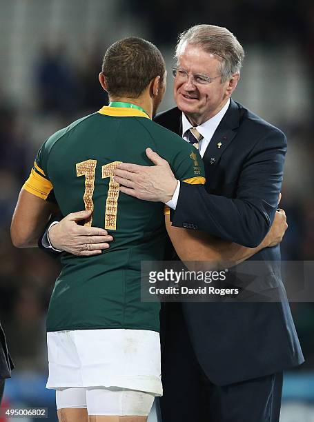 Chairman of the World Rugby Bernard Lapasset hugs Bryan Habana of South Africa after the 2015 Rugby World Cup Bronze Final match between South Africa...