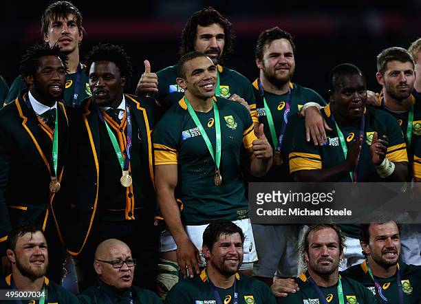 Victor Matfield and Bryan Habana of South Africa pose with their bronze medal and team mates after during the 2015 Rugby World Cup Bronze Final match...