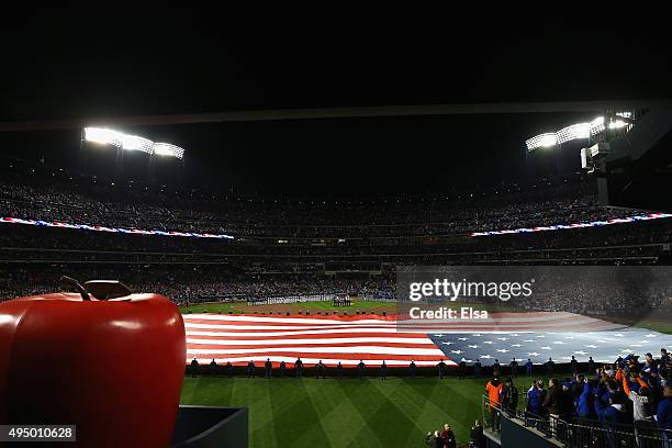 Giant American Flag is displayed on the field prior to Game Three of the 2015 World Series at Citi Field between the New York Mets and the Kansas...