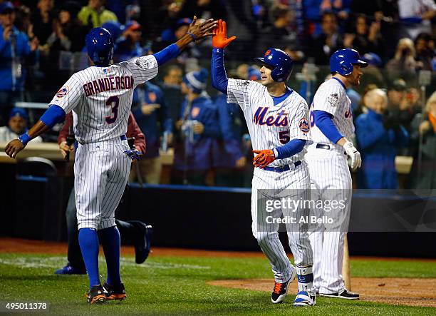 David Wright of the New York Mets celebrates with Curtis Granderson after hitting a two run home run in the first inning against the Kansas City...