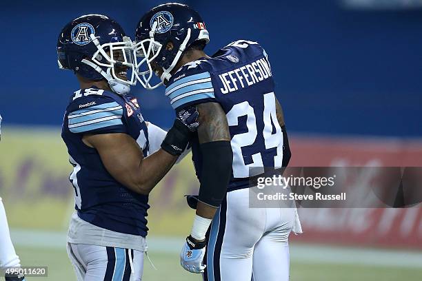 Devin Smith congratulates Toronto Argonauts defensive back A.J. Jefferson after he intercepted a pass as the Toronto Argonauts play the BC Lions in...