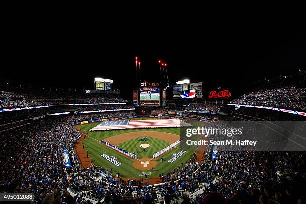 General view as a giant American Flag is displayed on the field prior to Game Three of the 2015 World Series at Citi Field between the New York Mets...