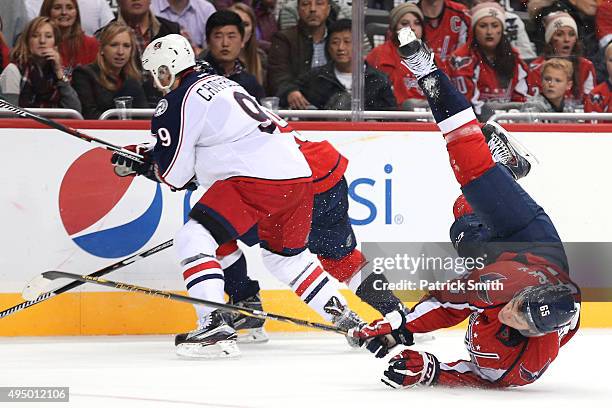 Andre Burakovsky of the Washington Capitals crashes to the ice after colliding with a teammate in the second period against the Columbus Blue Jackets...