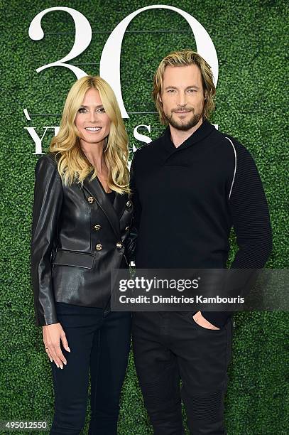 Heidi Klum and Gabriel Aubry attend the Glamour and INC International Concepts Denim Dash with Heidi Klum at Herald Square on October 30, 2015 in New...