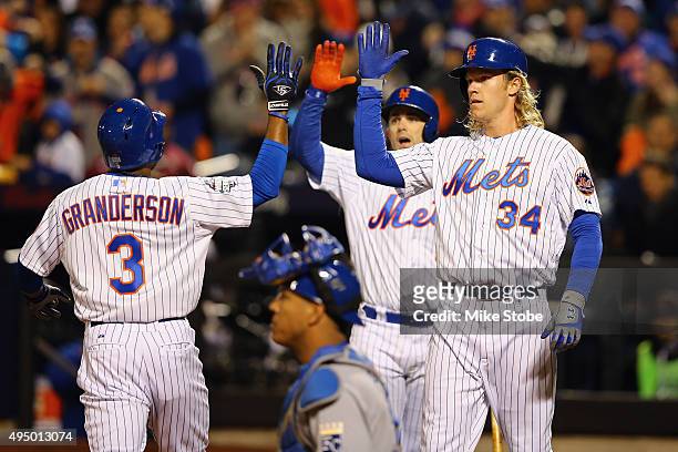 Curtis Granderson of the New York Mets celebrates with Noah Syndergaard and David Wright after hitting a two run home run in the third inning against...