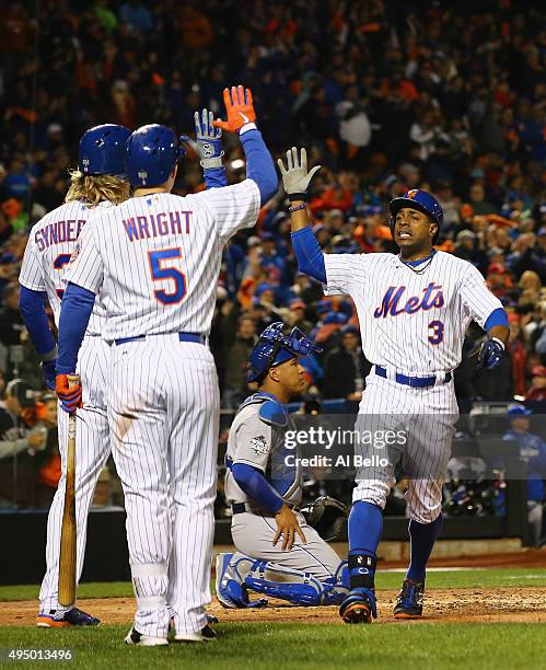 Curtis Granderson of the New York Mets celebrates with Noah Syndergaard and David Wright after hitting a two run home run in the third inning against...