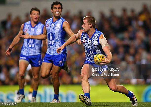 Leigh Adams of the Kangaroos looks to pass the ball during the round 11 AFL match between the West Coast Eagles and the North Melbourne Kangaroos at...