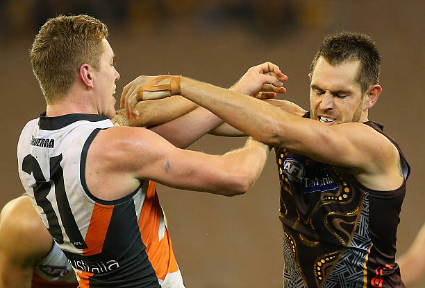 Jacob Townsend of the Giants and Luke Hodge of the Hawks push each other during the round 11 AFL match between the Hawthorn Hawks and the Greater...