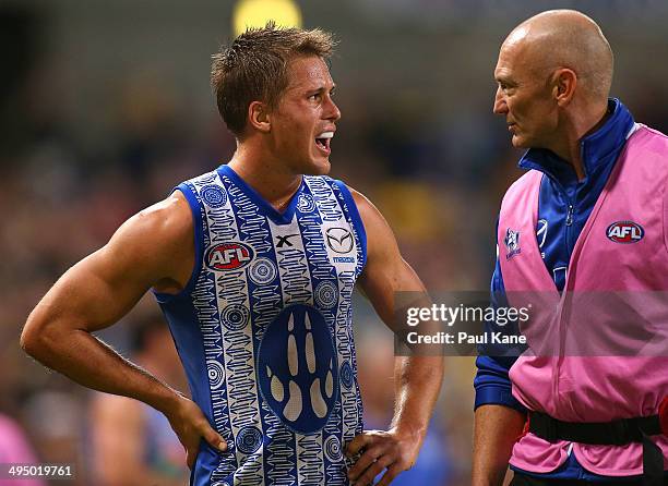 Andrew Swallow of the Kangaroos talks to a trainer after coming from the field during the round 11 AFL match between the West Coast Eagles and the...