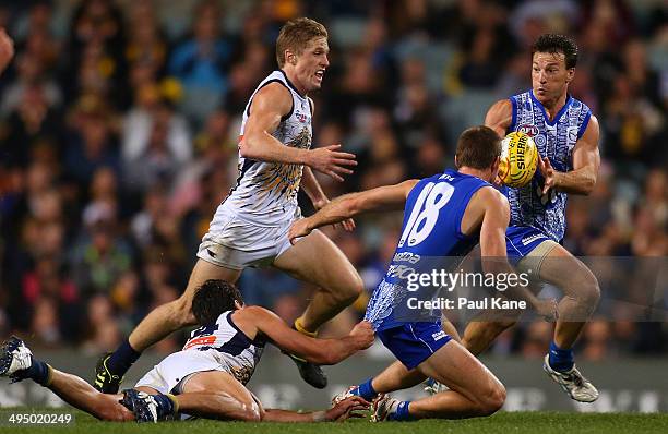 Brent Harvey of the Kangaroos receives a handball from Shaun Atley during the round 11 AFL match between the West Coast Eagles and the North...