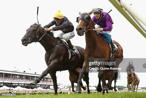 Jockey Dwayne Dunn riding Excess Knowledge leads Damien Lane riding Zanteca across the line to win race 5 The Lexus Stakes on Derby Day at Flemington...