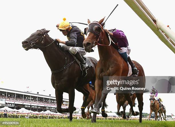 Jockey Dwayne Dunn riding Excess Knowledge leads Damien Lane riding Zanteca across the line to win race 5 The Lexus Stakes on Derby Day at Flemington...