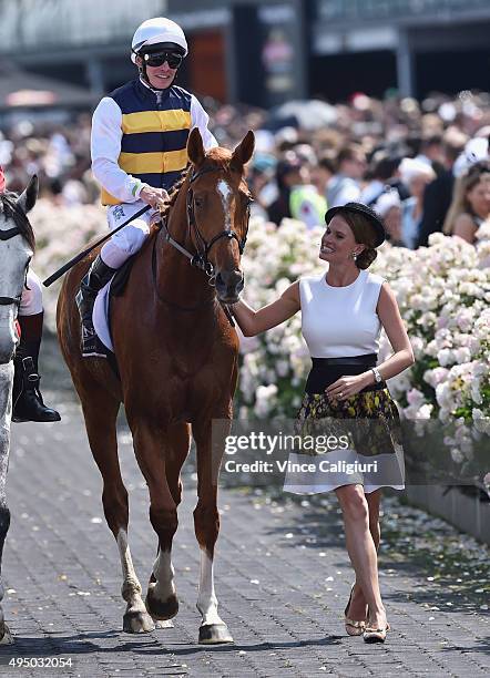 Ben Melham riding Gailo Chop is lead in by Francesca Cumani after winning Race 6, the Longines MacKinnon Stakes on Derby Day at Flemington Racecourse...