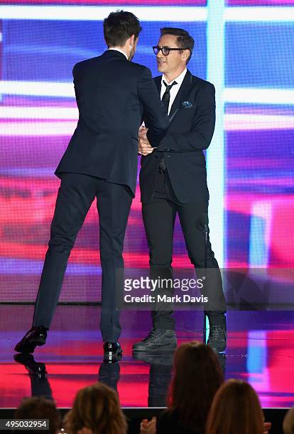 Host Jack Whitehall and actor Robert Downey Jr. Speak onstage during the 2015 Jaguar Land Rover British Academy Britannia Awards presented by...