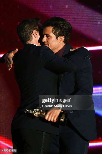 Honoree Orlando Bloom accepts the Britannia Humanitarian Award from actor Robert Downey Jr. Onstage during the 2015 Jaguar Land Rover British Academy...