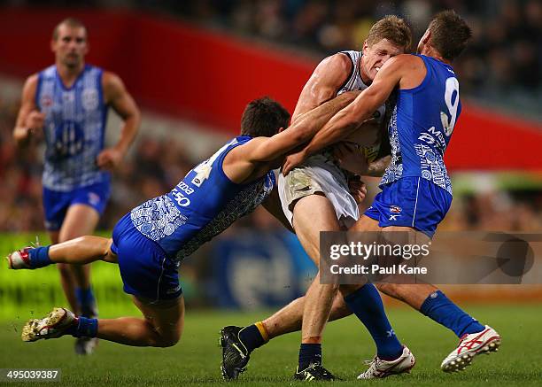 Scott Selwood of the Eagles gets tackled by Levi Greenwood and Andrew Swallow of the Kangaroos during the round 11 AFL match between the West Coast...