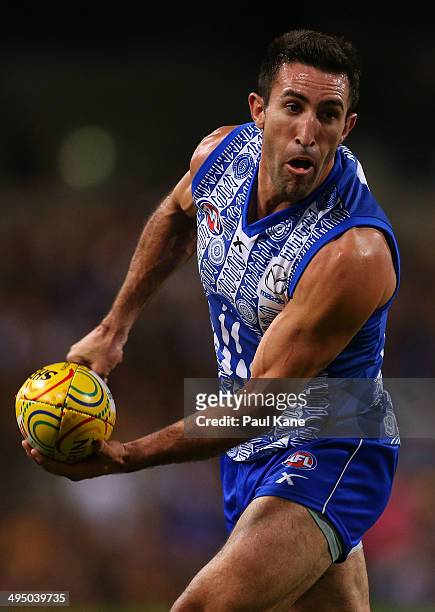 Michael Firrito of the Kangaroos looks to handball during the round 11 AFL match between the West Coast Eagles and the North Melbourne Kangaroos at...