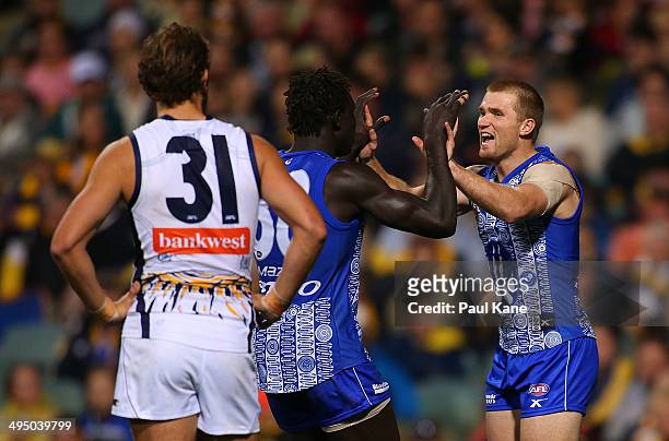 Majak Daw and Leigh Adams of the Kangaroos celebrate a goal during the round 11 AFL match between the West Coast Eagles and the North Melbourne...