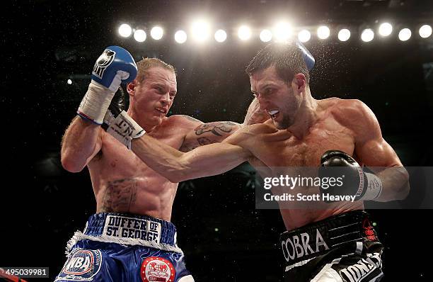 George Groves in action with Carl Froch in their IBF and WBA World Super Middleweight bout at Wembley Stadium on May 31, 2014 in London, England.