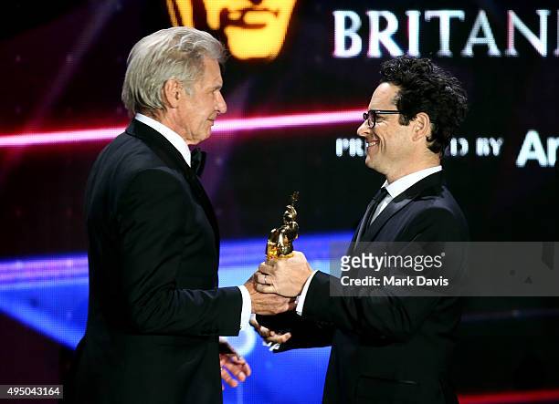 Honoree Harrison Ford accepts the Albert R. Broccoli Britannia Award for Worldwide Contribution to Entertainment from director J.J. Abrams onstage...