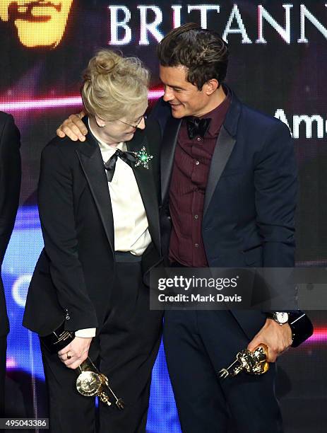 Honorees Meryl Streep and Orlando Bloom stand onstage during the 2015 Jaguar Land Rover British Academy Britannia Awards presented by American...