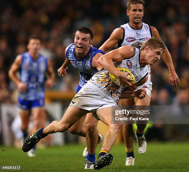 Scott Selwood of the Eagles looks to avoid being tackled by Luke McDonald of the Kangaroos during the round 11 AFL match between the West Coast...