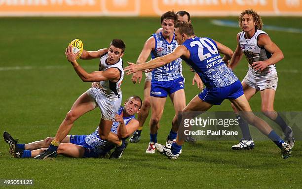 Elliot Yeo of the Eagles gets tackled by Ben Cunnington of the Kangaroos during the round 11 AFL match between the West Coast Eagles and the North...