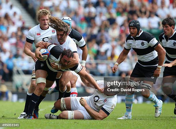 Mamuka Gorgodze of the Barbarians is tackled by Luke Wallace and Dave Ewers of England during the Rugby Union International Match between England and...