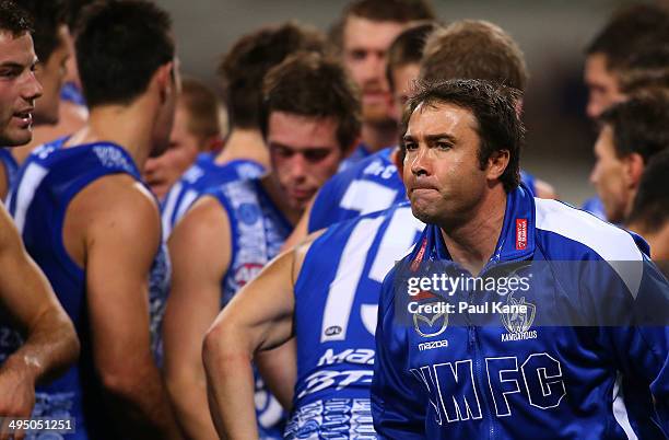 Brad Scott, coach of the Kangaroos heads back to the coaches box after addressing his players at the three quarter time break during the round 11 AFL...