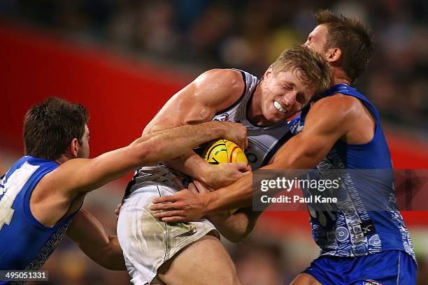 Scott Selwood of the Eagles gets tackled by Levi Greenwood and Andrew Swallow of the Kangaroos during the round 11 AFL match between the West Coast...