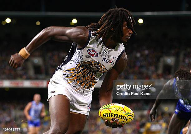 Nic Naitanui of the Eagles looks to handball during the round 11 AFL match between the West Coast Eagles and the North Melbourne Kangaroos at...