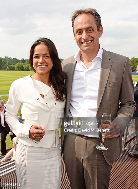 Michelle Rodriguez and Andre Konsbruck, Director of Audi UK, attend day two of the Audi Polo Challenge at Coworth Park Polo Club on June 1, 2014 in...