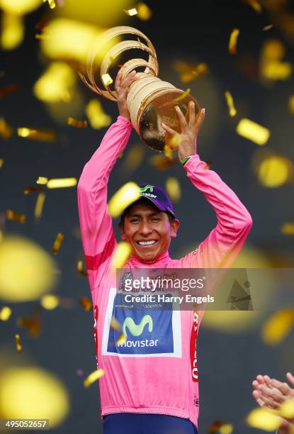 Nairo Quintana of Colombia and team Movistar lifts the winners trophy, the 'Trofeo Senza Fine', following the twenty-first stage of the 2014 Giro...