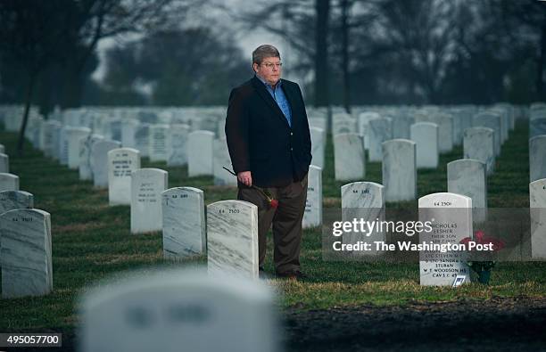 Steve Stuban at the grave of his son Nick, a Woodson High School student who took his own life in Arlington, VA on March 29, 2014. In 2011 Nick was a...