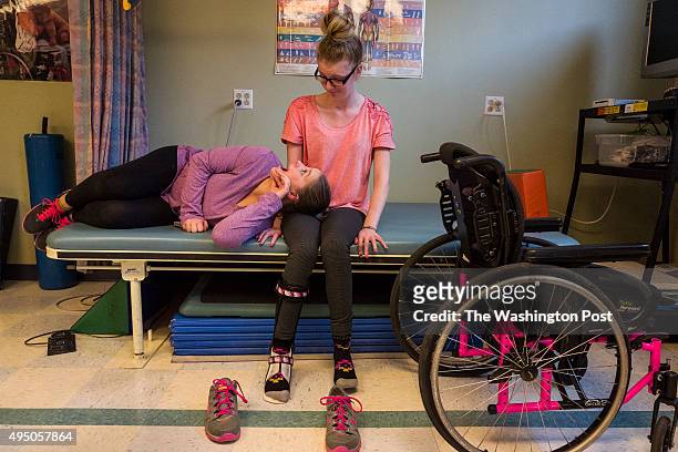 Hannah Terry left, shares a quiet moment with her cousin Morgan Brittain before a physical therapy session at the Childrens Development and...