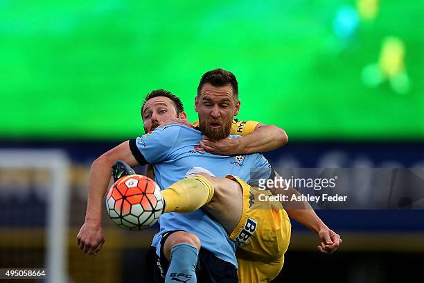 Shane Smeltz of Sydney FC contests the ball against Joshua Rose of the Mariners during the round four A-League match between the Central Coast...