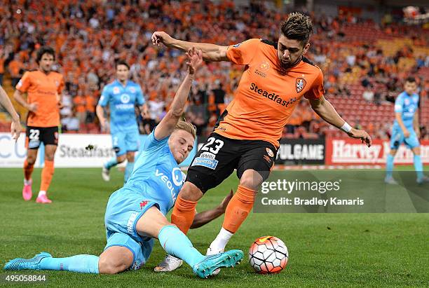 Dimitri Petratos of the Roar is tackled by James Jeggo of Adelaide during the round four A-League match between Brisbane Roar and Adelaide United at...
