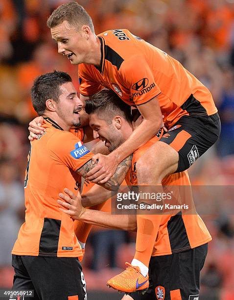 Brandon Borrello of the Roar is congratulated by team mates after scoring a goal during the round four A-League match between Brisbane Roar and...