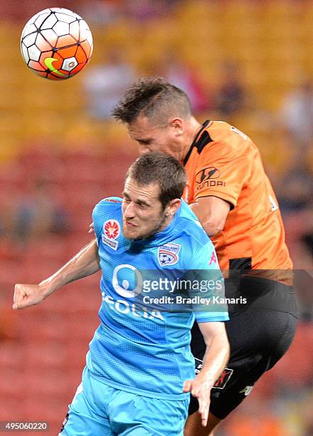 Jade North of the Roar and Mate Dugandzic of Adelaide challenge for the ball during the round four A-League match between Brisbane Roar and Adelaide...