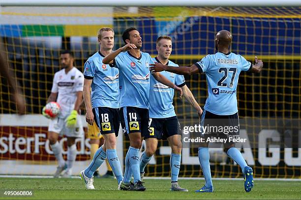 Sydney FC players celebrate a goal from Matthew Simon with Paul Izzo goalkeeper of the Mariners looking dejected in frame during the round four...